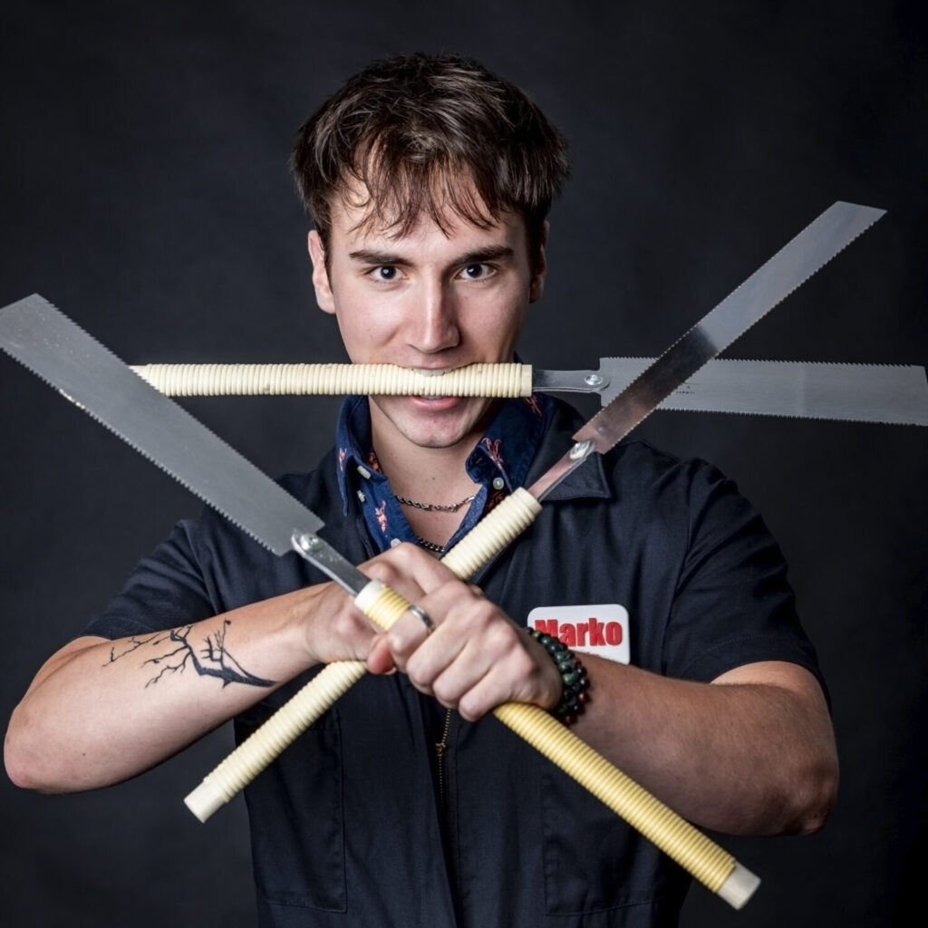 student team member posing with a saw