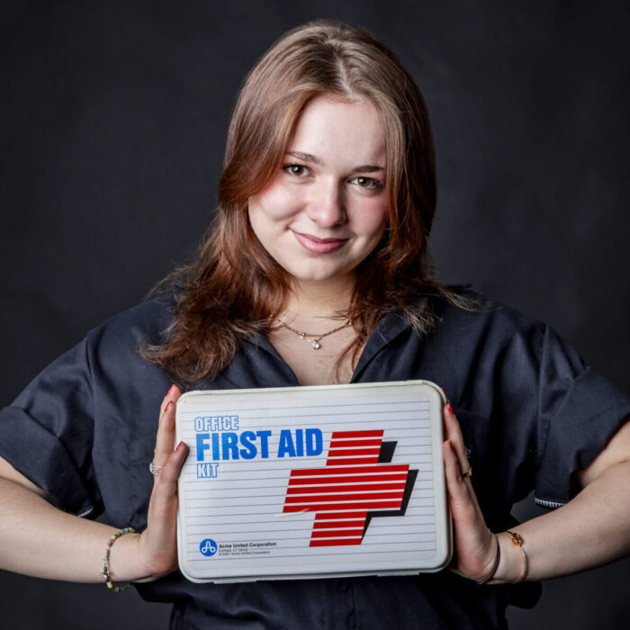 Woman holding a first aid kit and smiling