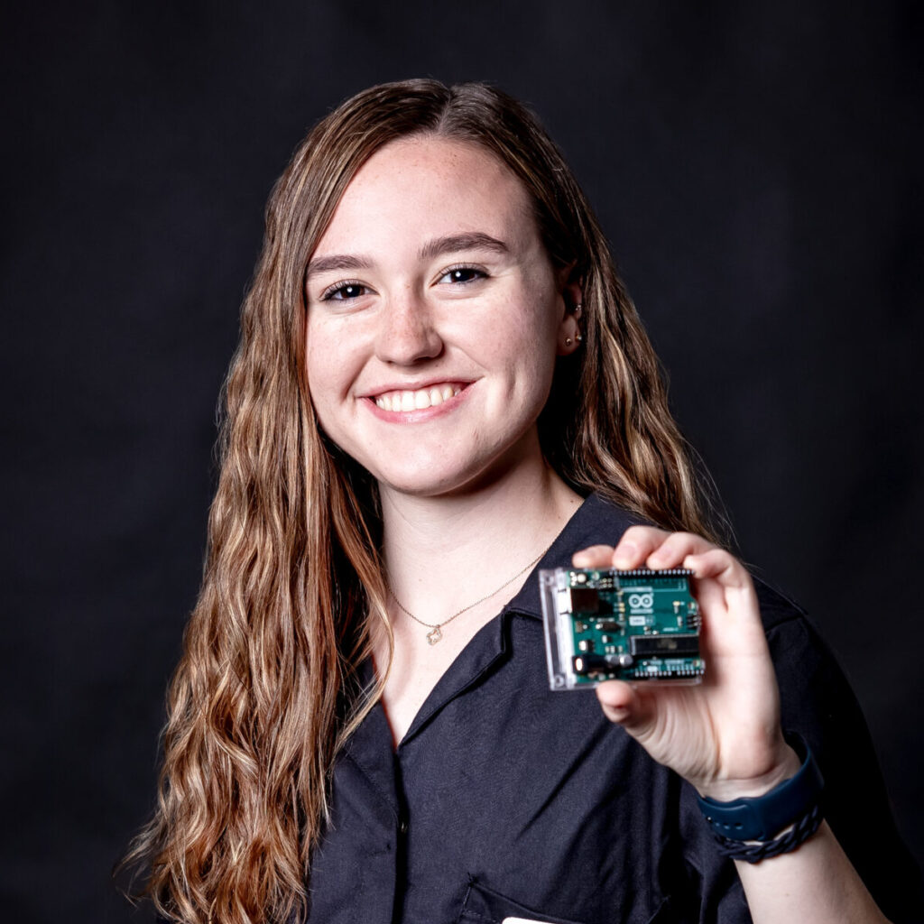 student portrait holding an arduino board