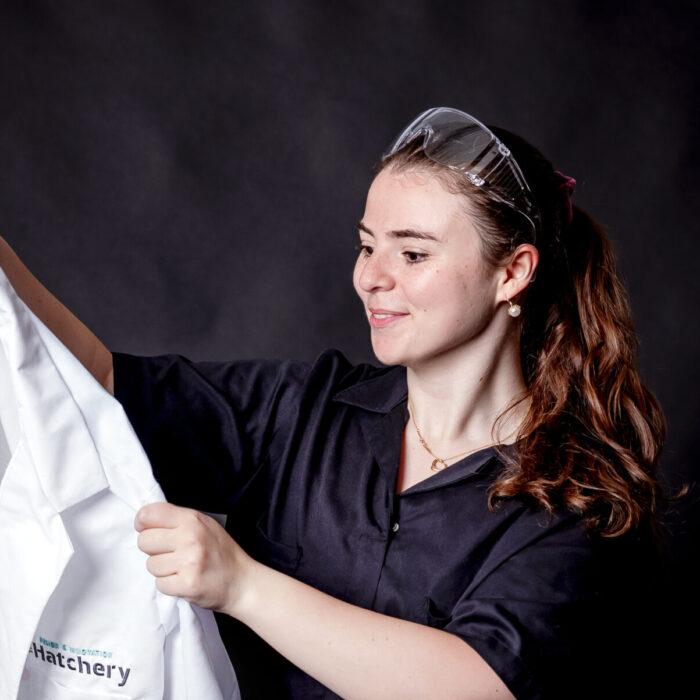 student portrait holding a lab coat