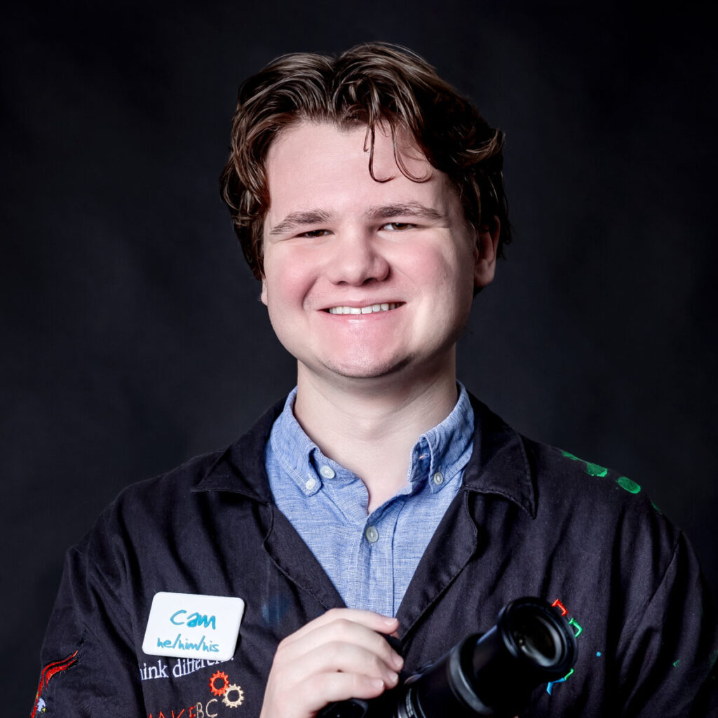 student portrait holding a camera