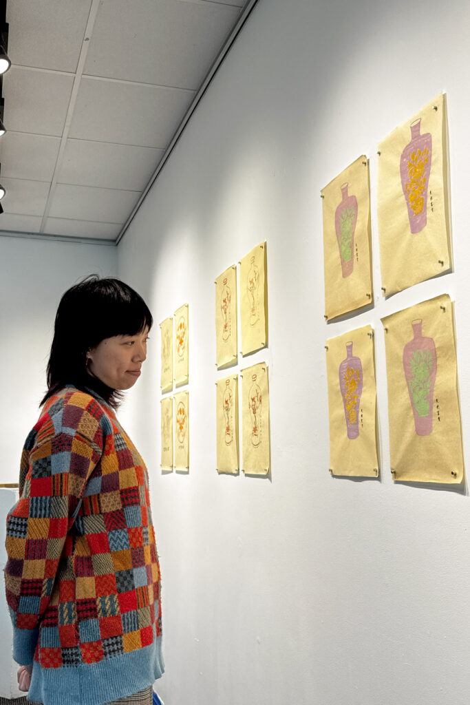 student admiring art hanging on wall